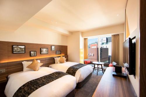 Ένα ή περισσότερα κρεβάτια σε δωμάτιο στο karaksa hotel premier Tokyo Ginza