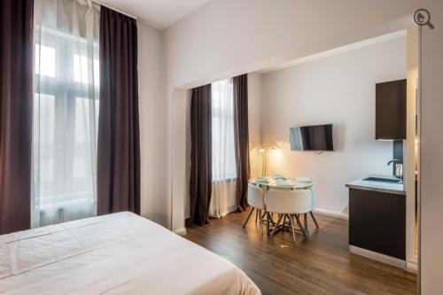 a hotel room with a bed and a small table at Passion Downtown Suite in Belgrade