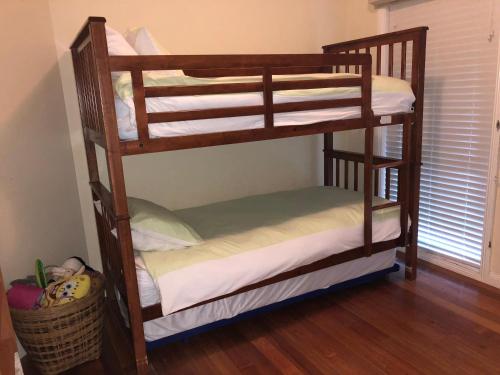 a couple of bunk beds in a room at Seagrape Cottage in Ocean Grove