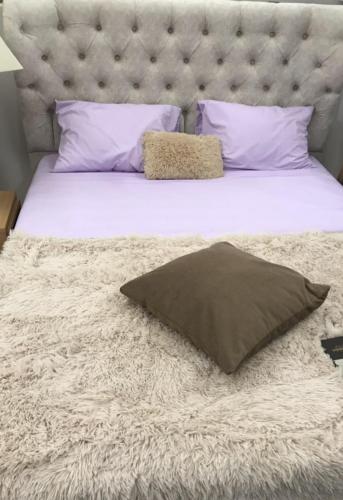 a bed with a pillow on top of it at City Villa -amazing view in Alepou