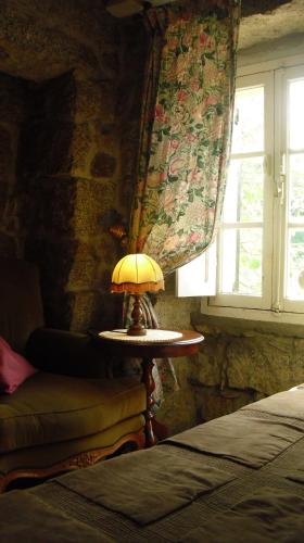 a lamp on a table in a room with a window at Maison d'Hôtes de Charme de Croccano in Sartène