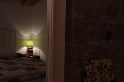 a bedroom with a bed and a lamp in a room at Al Libro Letto in Viterbo