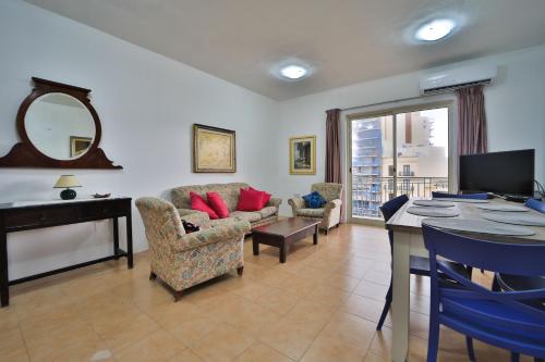 a living room with a couch and a table at Island Break Residence in Marsalforn