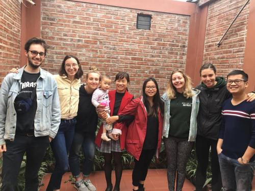 a group of people standing in front of a brick wall at Van Long Family Homestay in Ninh Binh