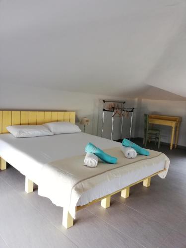 a white bed with two towels on top of it at Thea Houses in Milina