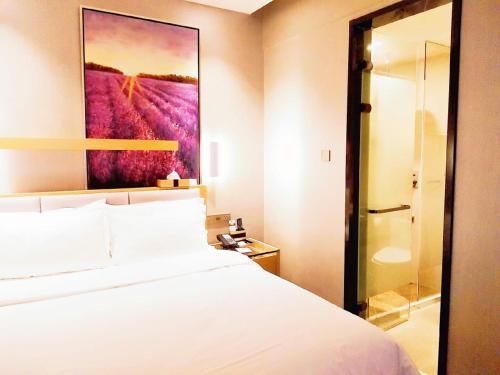En eller flere senger på et rom på Lavande Hotel Taixing Jiangping Road