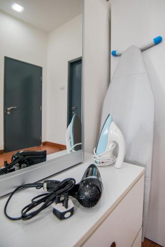 a desk with a mirror and a lamp on it at DaMen Homestay @SubangHomeStay in Subang Jaya