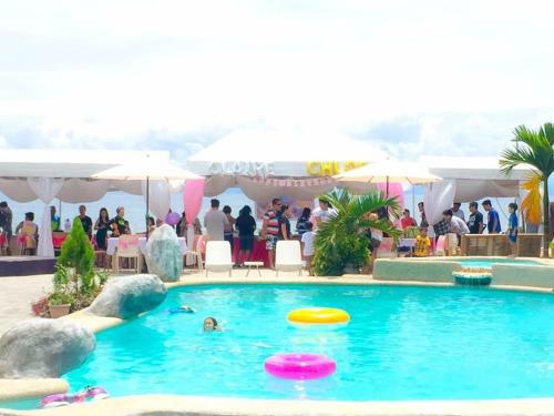 a group of people in a swimming pool with two frisbees at Estrella Del Mar in Toledo City
