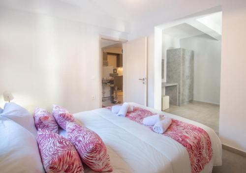 a bedroom with a large bed with pillows on it at Ithaka Zante City Villa by "elite" in Zakynthos Town