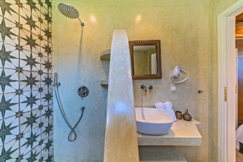 a bathroom with a sink and a shower at Mediterraneo Luxury Suites Halkidiki in Vourvourou