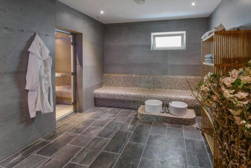 a bathroom with a shower and a tub with a toilet at Der Kramerhof in Dießen am Ammersee