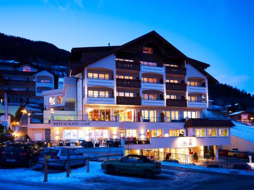 a large building with cars parked in front of it at Alpen-Herz Romantik & Spa - Adults Only in Ladis