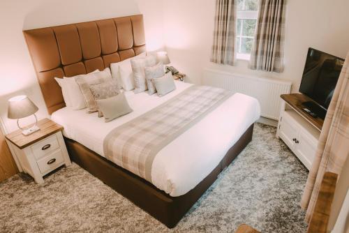 A bed or beds in a room at Nant Ddu Lodge Hotel & Spa