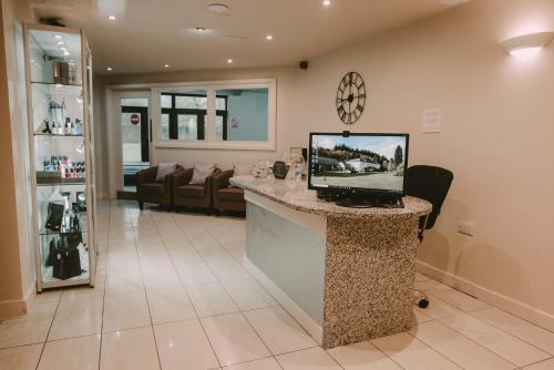 a living room with a counter with a computer on it at Nant Ddu Lodge Hotel & Spa in Merthyr Tydfil