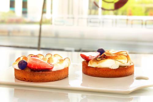 two pastries on a white plate on a table at Grand Hotel Continental Bucuresti in Bucharest
