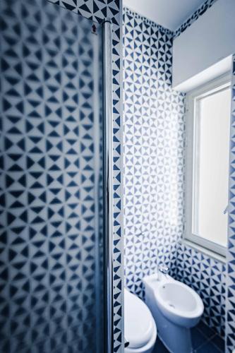 a bathroom with a toilet and a glass shower at On the beach Sea-view&Kitchen In Room in Salerno