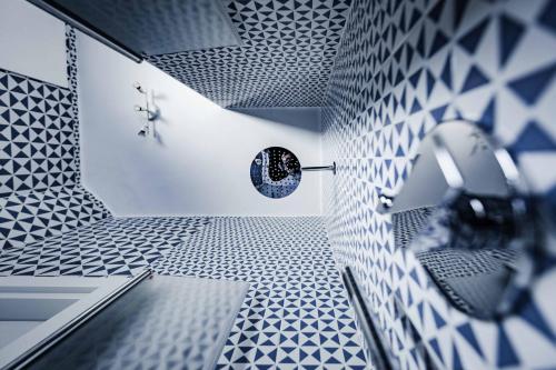 a bathroom with a blue and white tiled wall at On the beach Sea-view&Kitchen In Room in Salerno