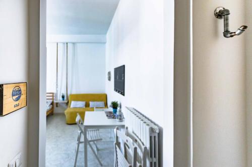 a living room with a yellow couch and a table at On the beach Sea-view&Kitchen In Room in Salerno