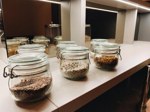 a counter with jars filled with different types of nuts at Hotel Mediteran in Zadar