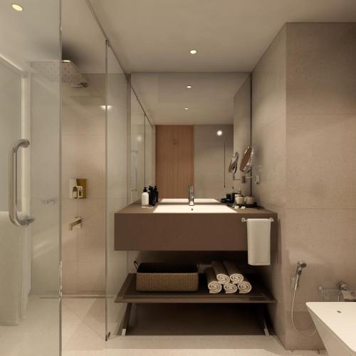 a bathroom with a sink and a shower at Sayaji Vadodara in Vadodara
