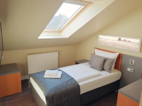 a bedroom with a large bed with a skylight at Gut Gnewikow in Gnewikow
