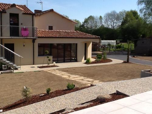 a house with a driveway in front of it at Gîtes de la Bibudière in Le Boupère