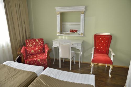a room with a table and two chairs and a mirror at Hotel Golden Dome Iisalmi in Iisalmi