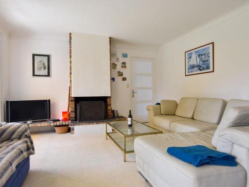 a living room with a couch and a fireplace at Peaceful holiday home near the beach in Pénestin