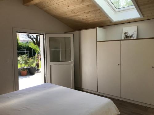 a bedroom with a white bed and a skylight at Jade B&B in Bouveret
