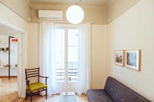 a living room with a couch and a chair at we saw athens in Athens