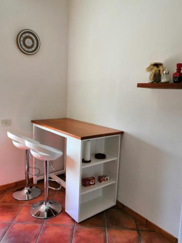 a table and two stools in a room at Zibibbo Apartment in Pantelleria