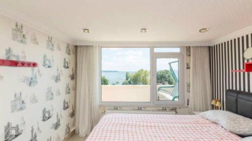 a bedroom with a bed and a large window at Front of Sea View Apartments Sultanahmet SEA VIEW in Istanbul