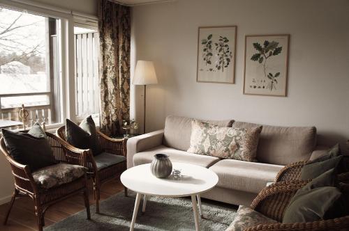 a living room with a couch and chairs and a table at Destination Bokenäset in Uddevalla