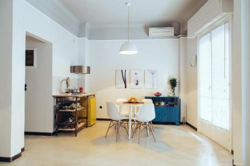 a kitchen with a table and chairs in a room at we saw athens in Athens