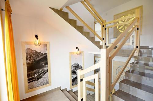 a staircase in a house with a painting on the wall at Dom Wczasowy Tatrzański in Szaflary