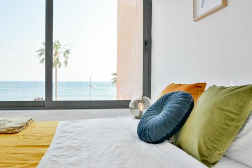 a bedroom with a bed with a pillow and a window at Phaedrus Living Seaview Luxury Flat Marina Court 213 in Paphos
