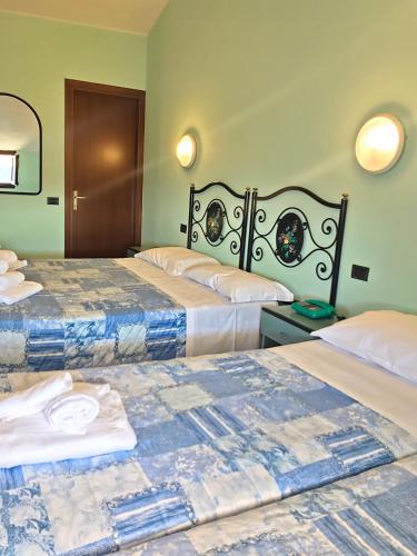 a hotel room with two beds in a room at Antiche Terre Hotel & Relax in Pignone