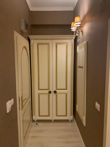 a hallway with a white door and a mirror at Hotel Goya Collection in Târgu Jiu
