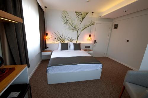 a bedroom with a large bed in a room at Luis Otel in Izmir
