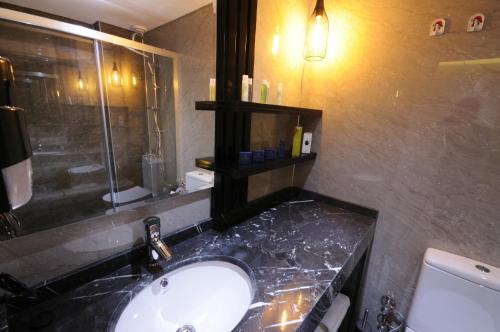 a bathroom with a sink and a shower at Luis Otel in Izmir