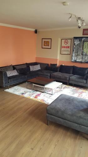 a living room with a couch and a coffee table at Hotel Crowded House in Eceabat