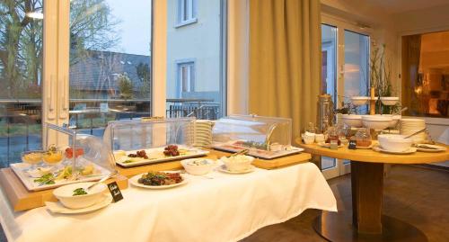 a table with plates of food on top of it at Hotel & Gutsgasthaus Köberle in Lindau
