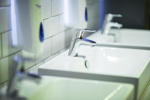 
a row of sinks in a bathroom at Kick Ass Grassmarket (18+) in Edinburgh
