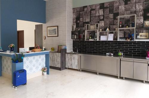 a restaurant lobby with a counter and a blue suitcase at Rethymno Blue Apartments in Rethymno Town