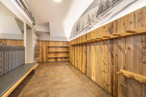 a tasting room with wooden walls and benches at Aparthotel Jägerheim in Flachau