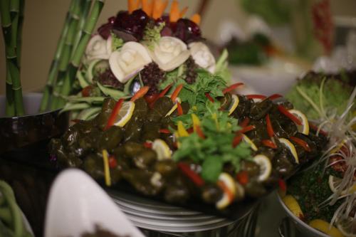 a plate of food with vegetables on a table at Violet Al Azizia Hotel MASJID Al Qatari in Makkah