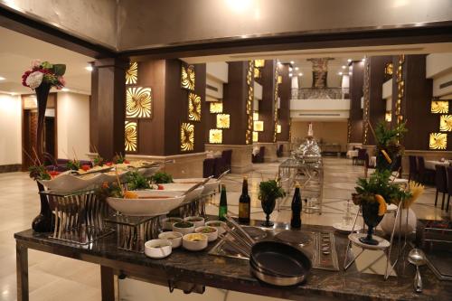 a buffet in a hotel lobby with food on a counter at Violet Al Azizia Hotel MASJID Al Qatari in Makkah