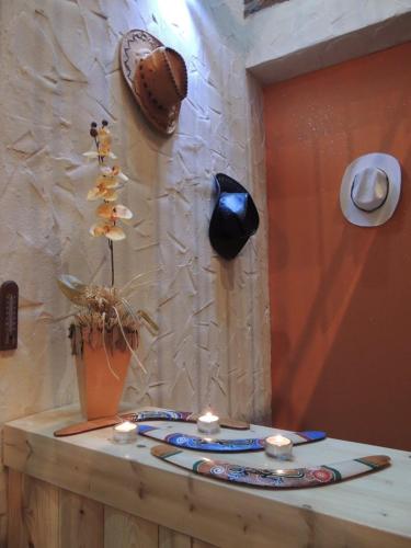 a stone wall with candles on a table at BoomerangHouse in Wrocław
