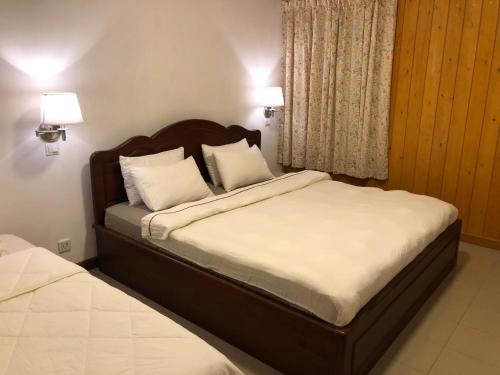 a bedroom with two beds with white pillows at Bungalow 28 in Nuwara Eliya
