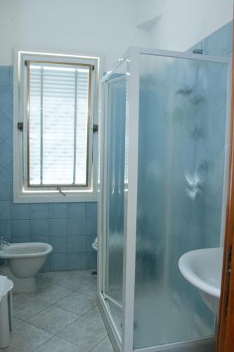 a bathroom with a shower and a sink at Hotel Ristorante Maga Circe in San Felice Circeo